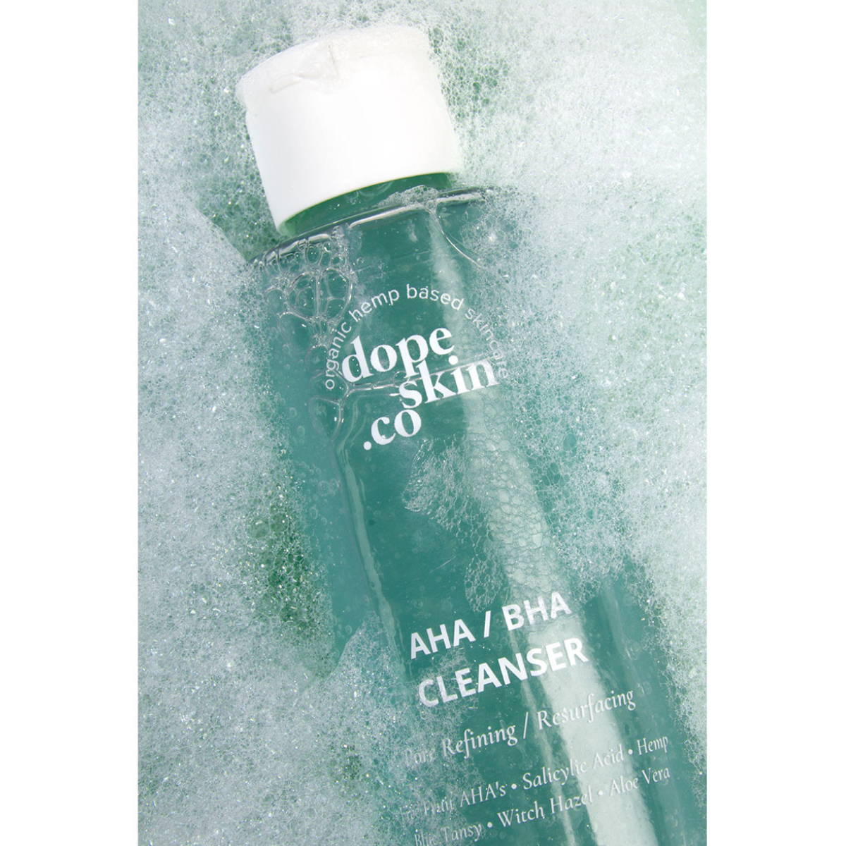 Image of Dope Skin Co AHA BHA Cleanser lying in bubbles