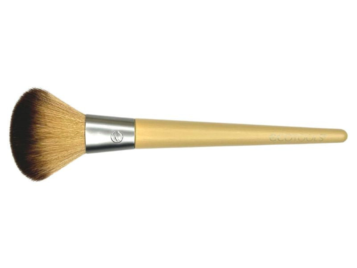 An Eco Tools blusher brush with a beige handle and synthetic domed bristles, designed for applying blush to the cheeks.