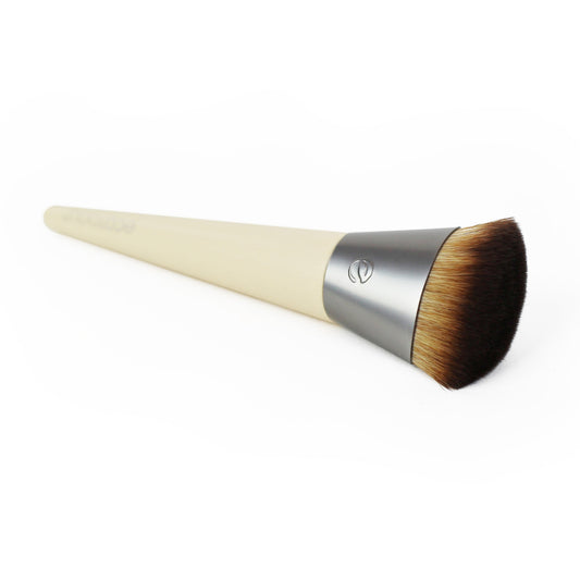 Eco tools foundation brush with beige handle and brown bristles on a white background