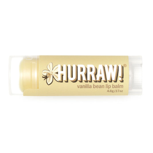 A stick of Hurraw! Vanilla Bean Lip Balm with the brand name and product description visible on the label.