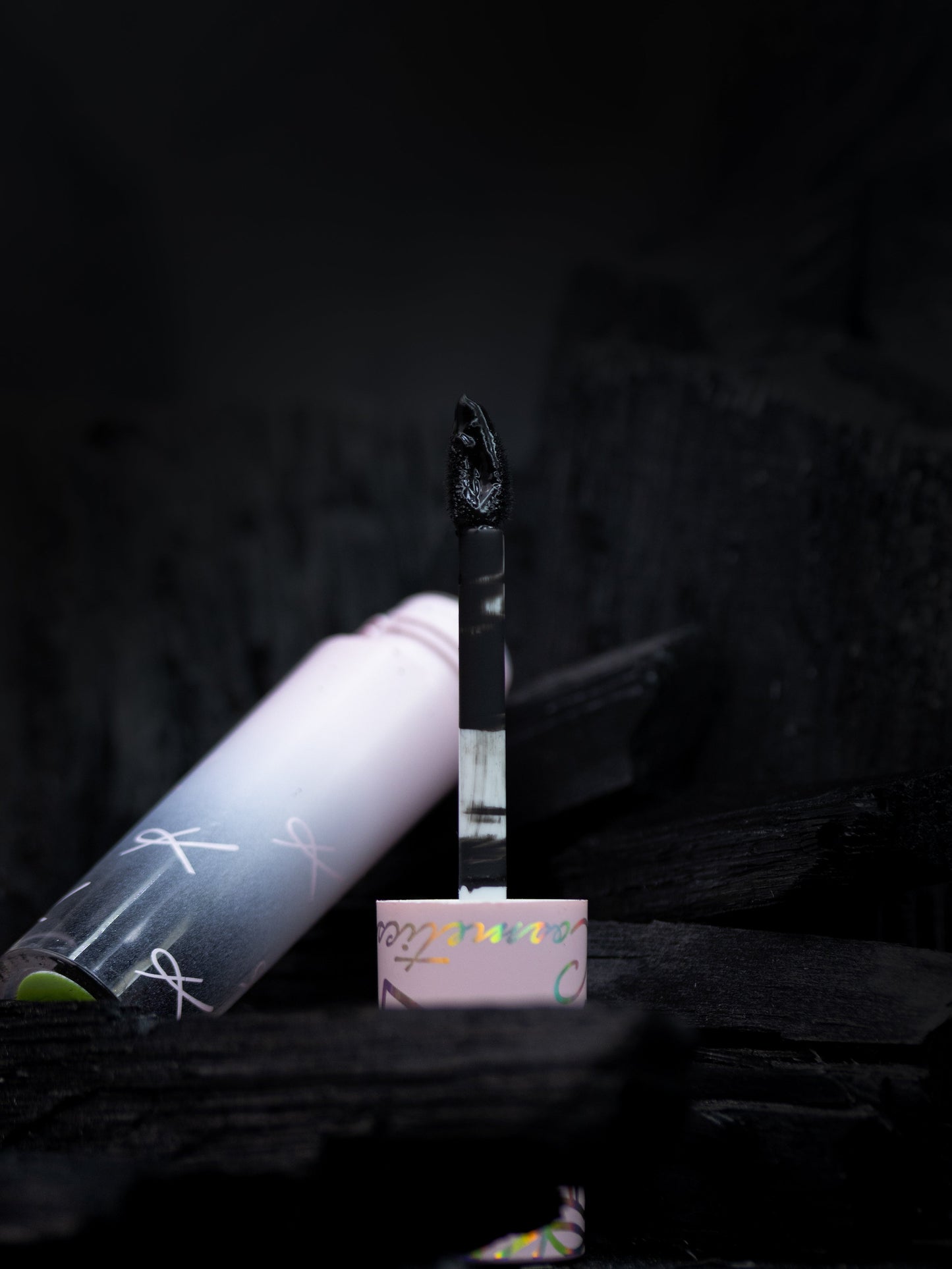 Cylindrical product with a brush-like end on a dark background