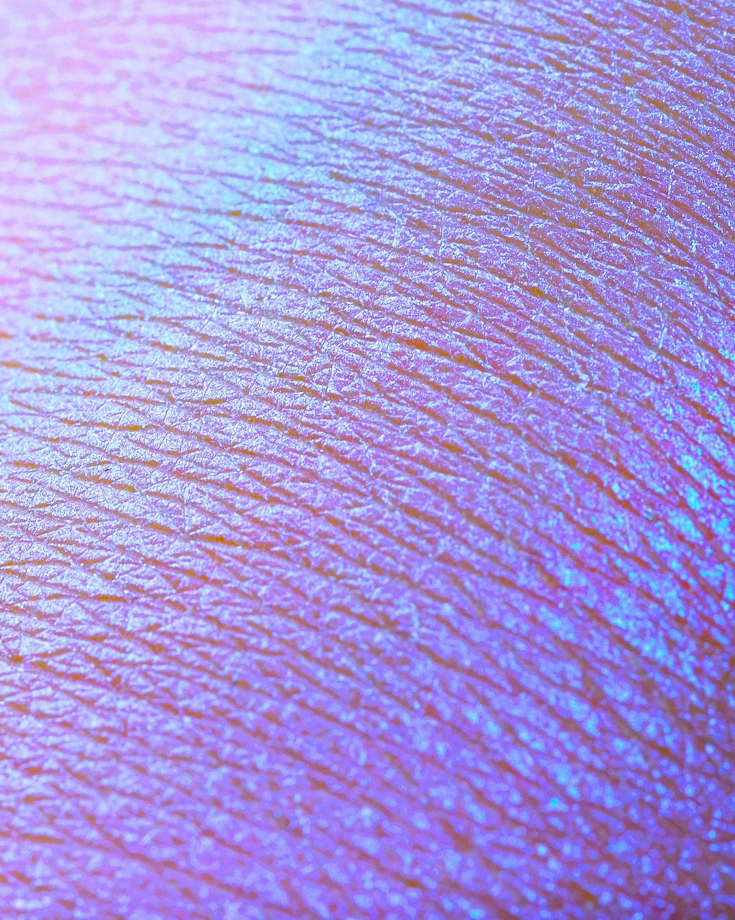 Close up textured swatch of opalescent eyeshadow on arm.
