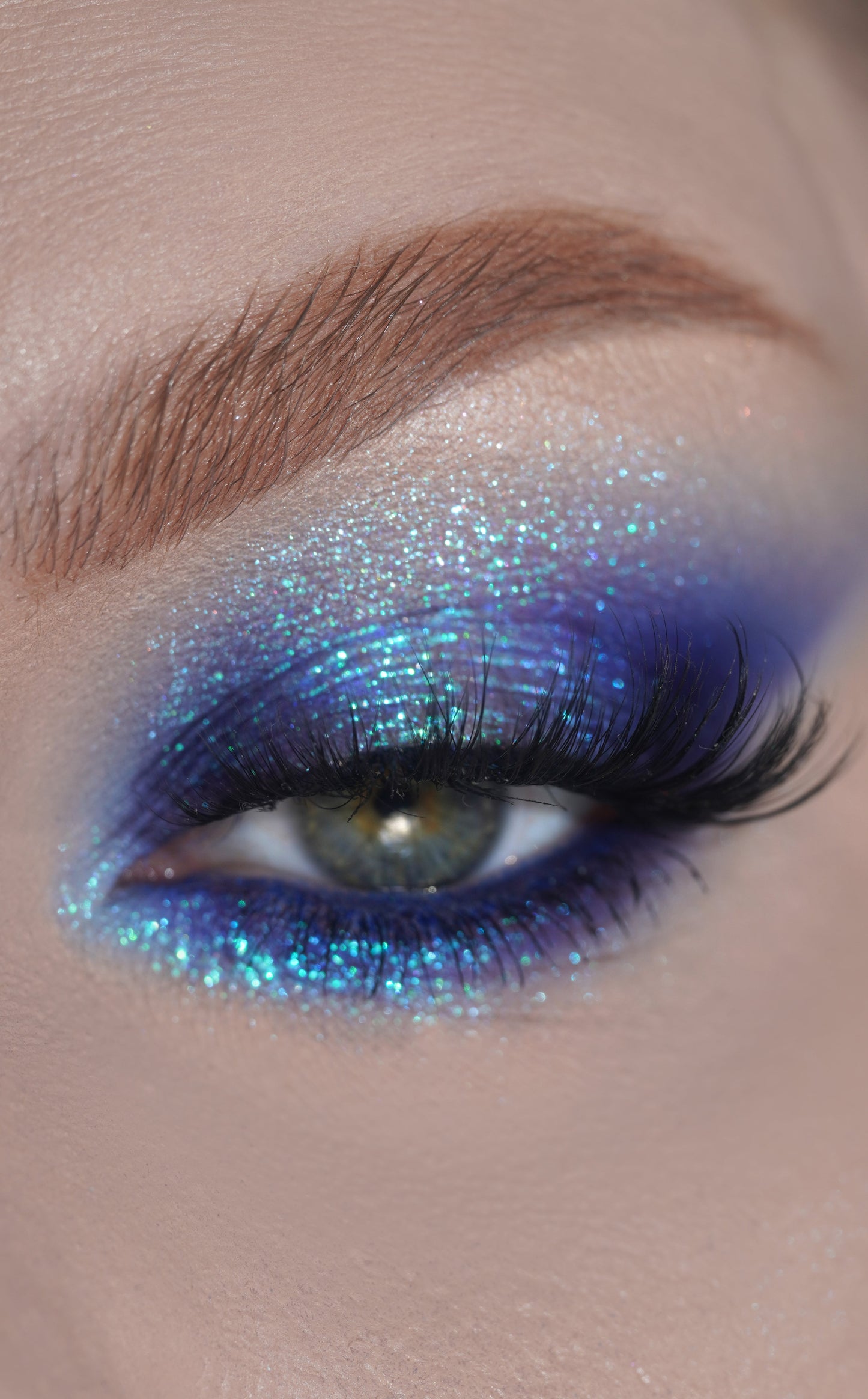 Close-up of a eye with blue glitter makeup in Dreamer