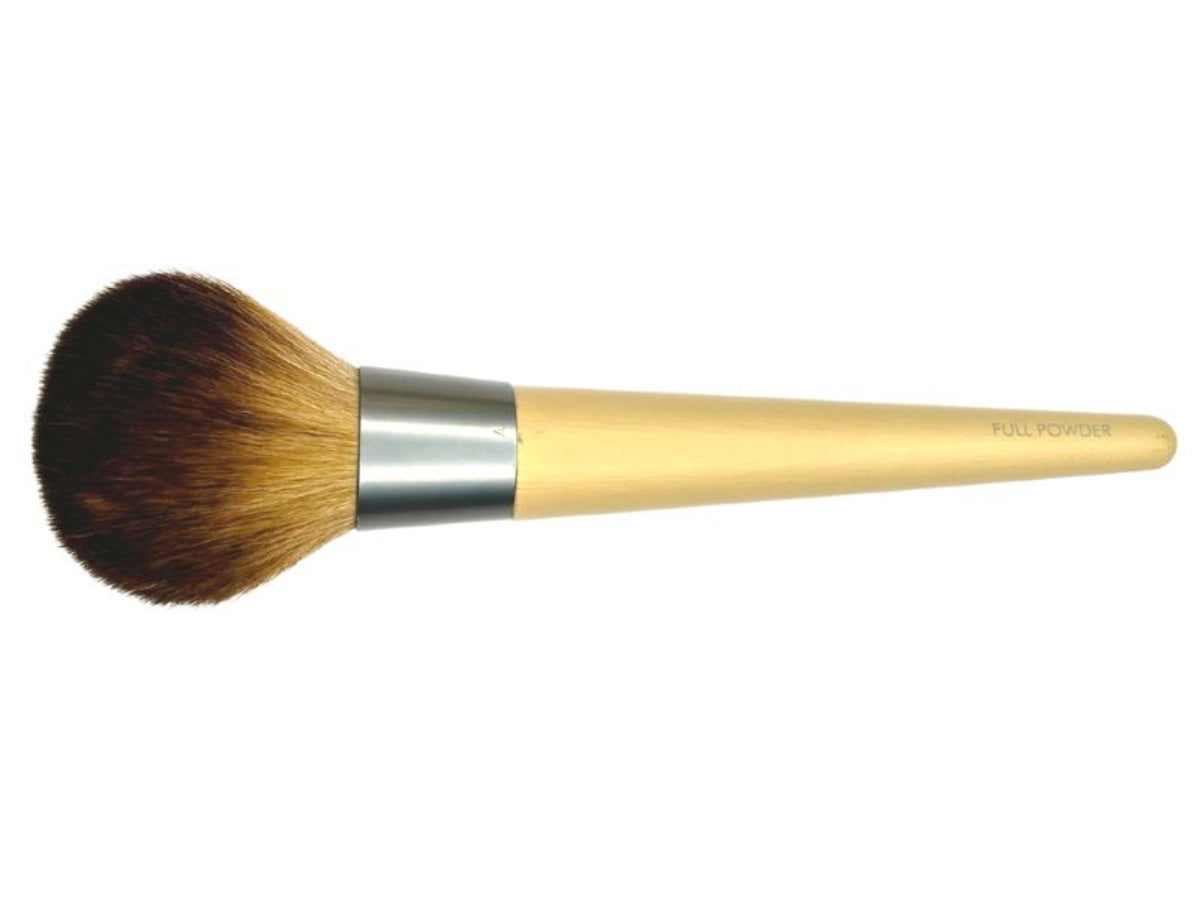 A large, flat powder brush with a beige handle and synthetic bristles, designed for applying pressed powder.