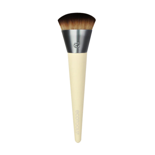An Eco Tools foundation brush with a beige handle and dome-shaped bristles