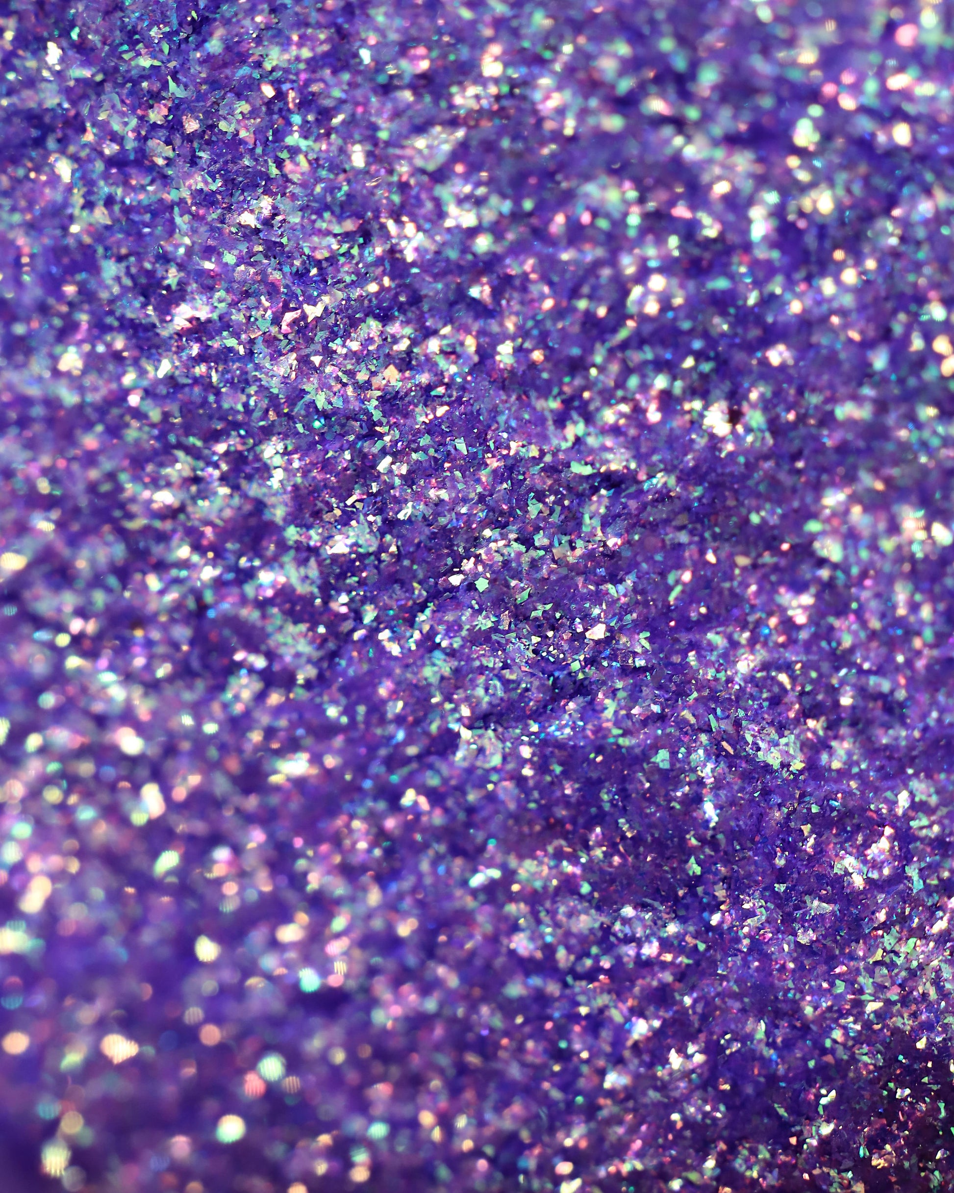 Close-up of purple glitter with a textured surface