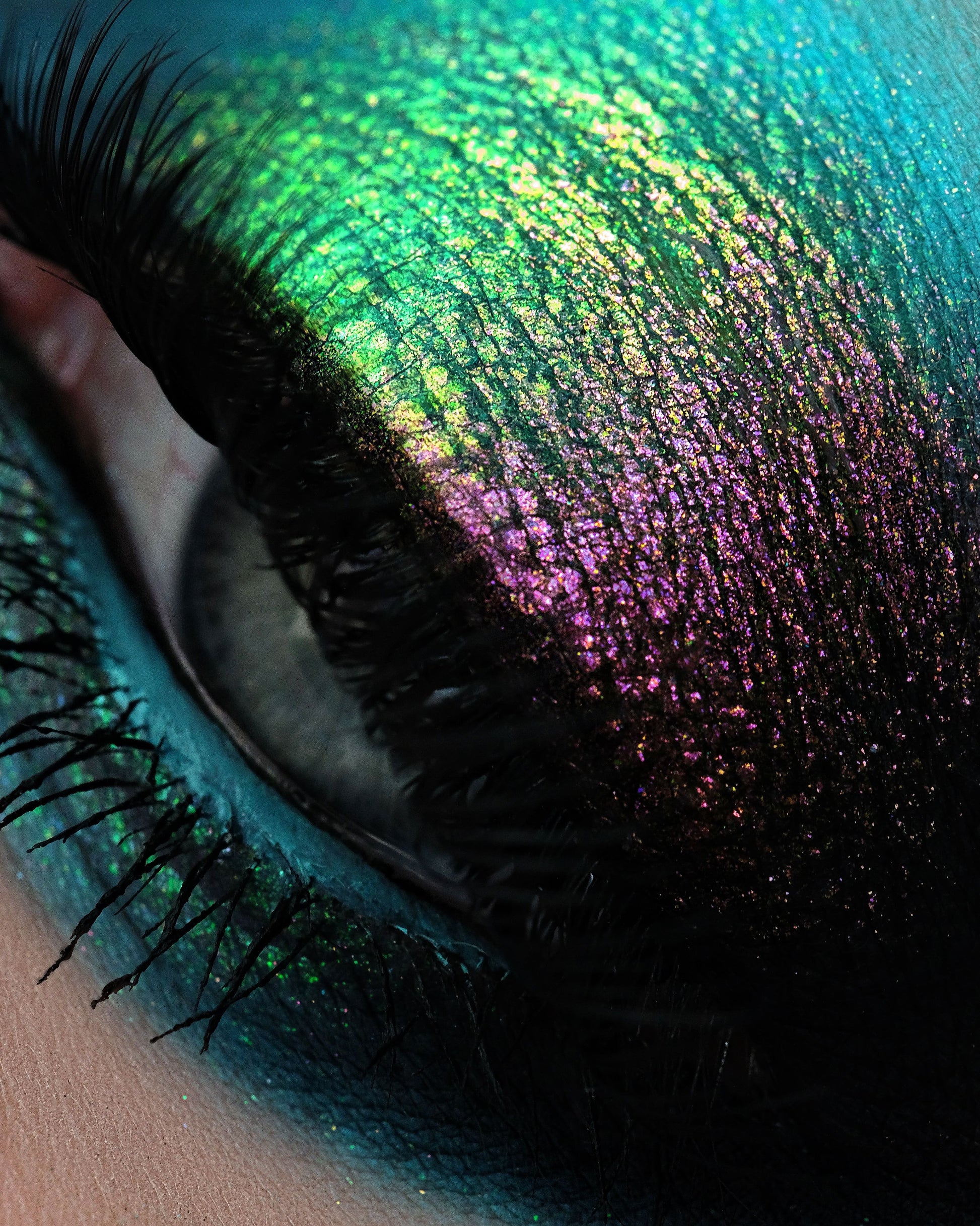 Close-up of a colorful eye with iridescent makeup