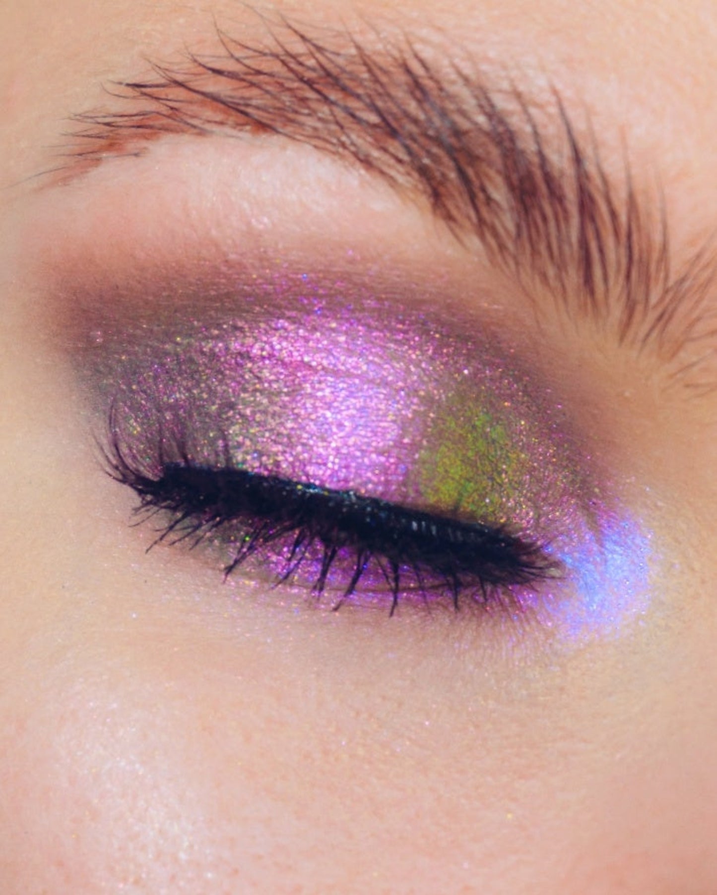 Close-up of a eye with purple and green makeup