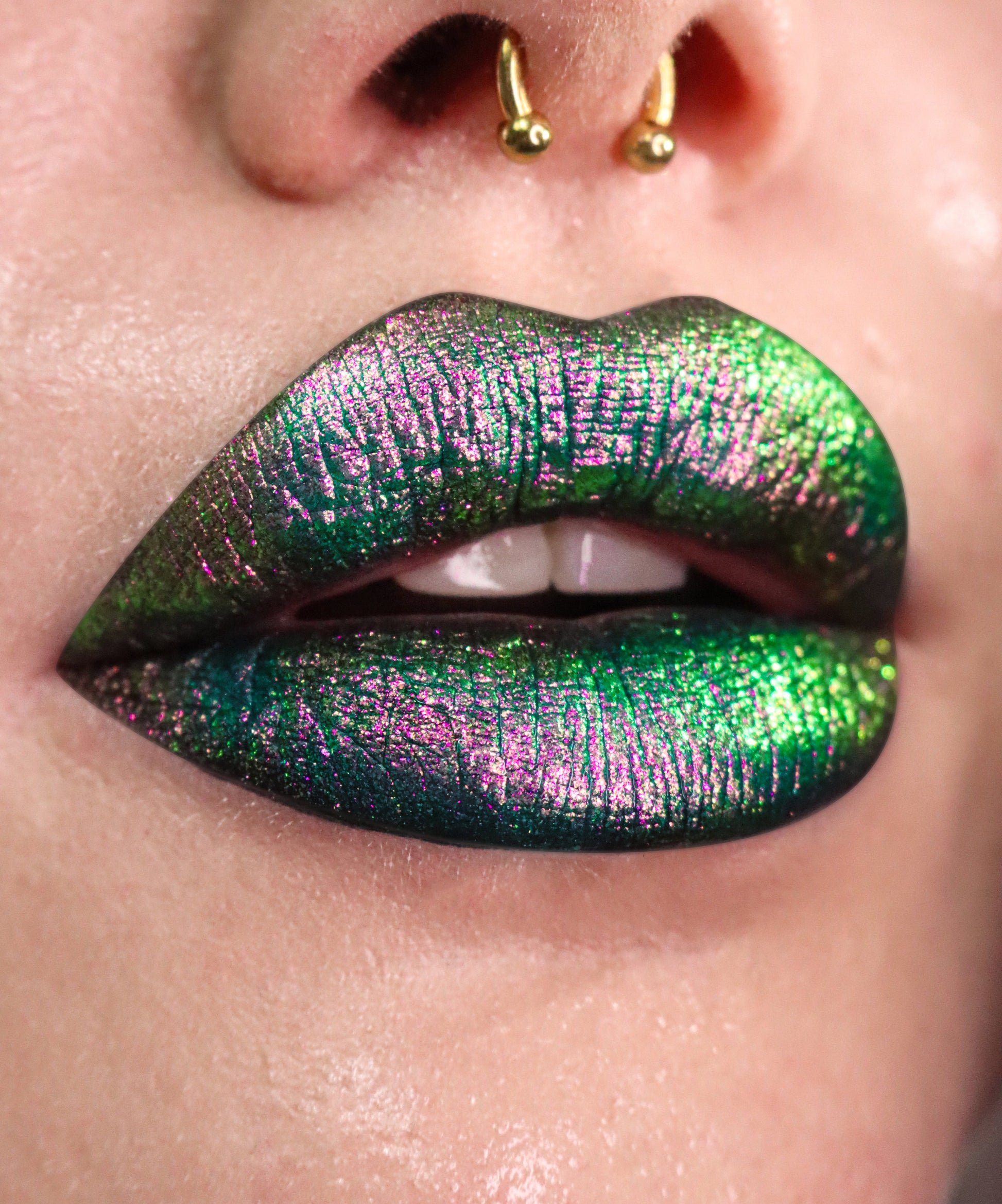 Close up on lips with black base and sparkly mulitchrome powder on top