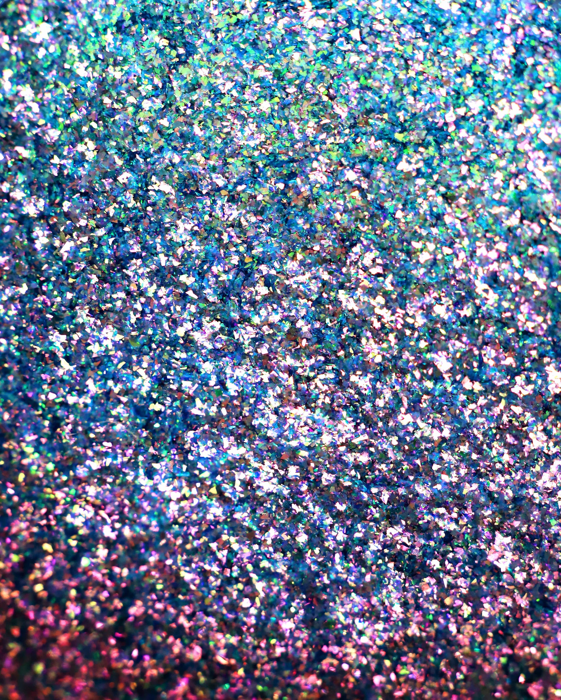 Close-up of glitter with multicolor specks on a blurred background