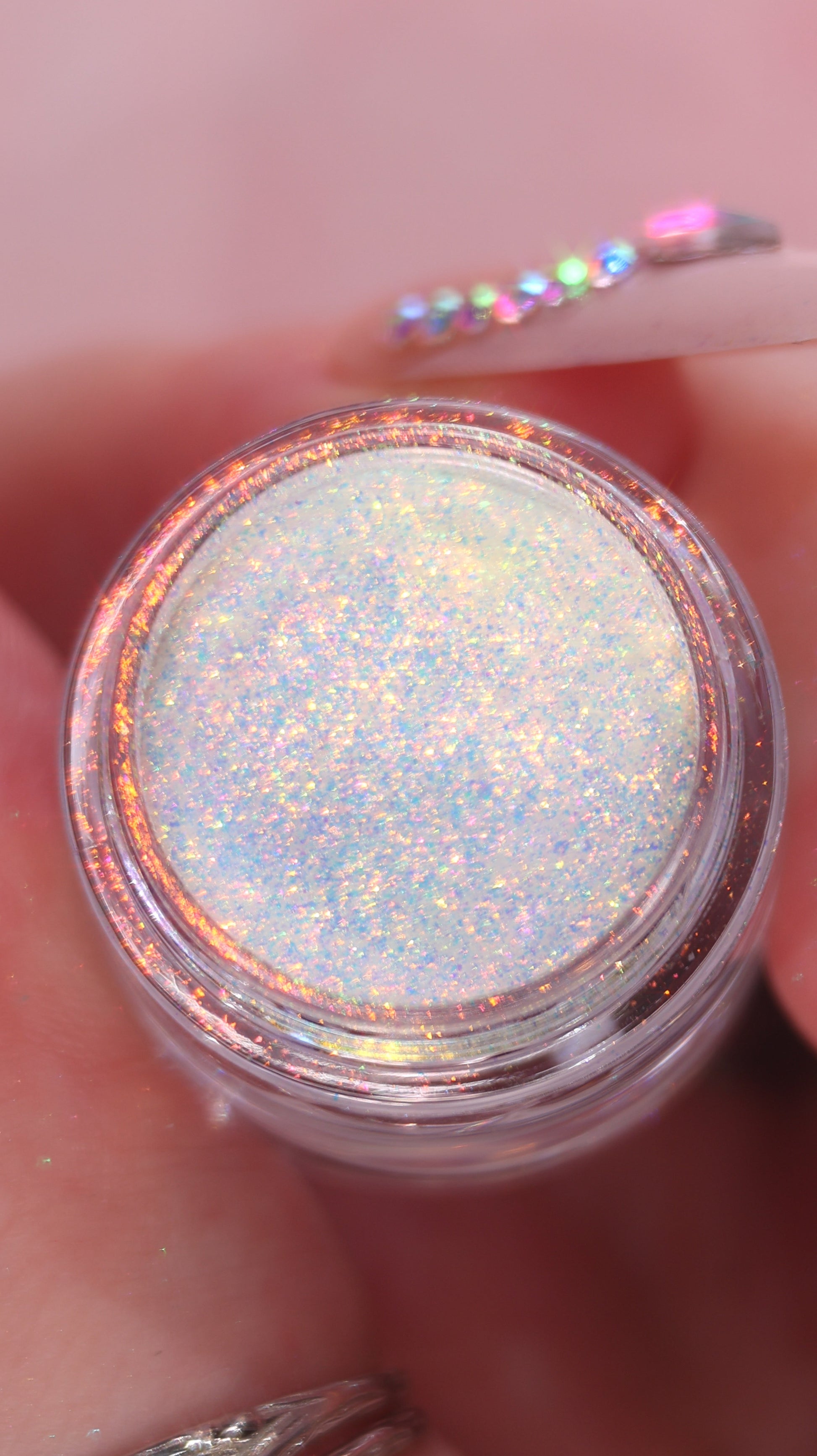 Close-up of a container of glitter with a blurred background