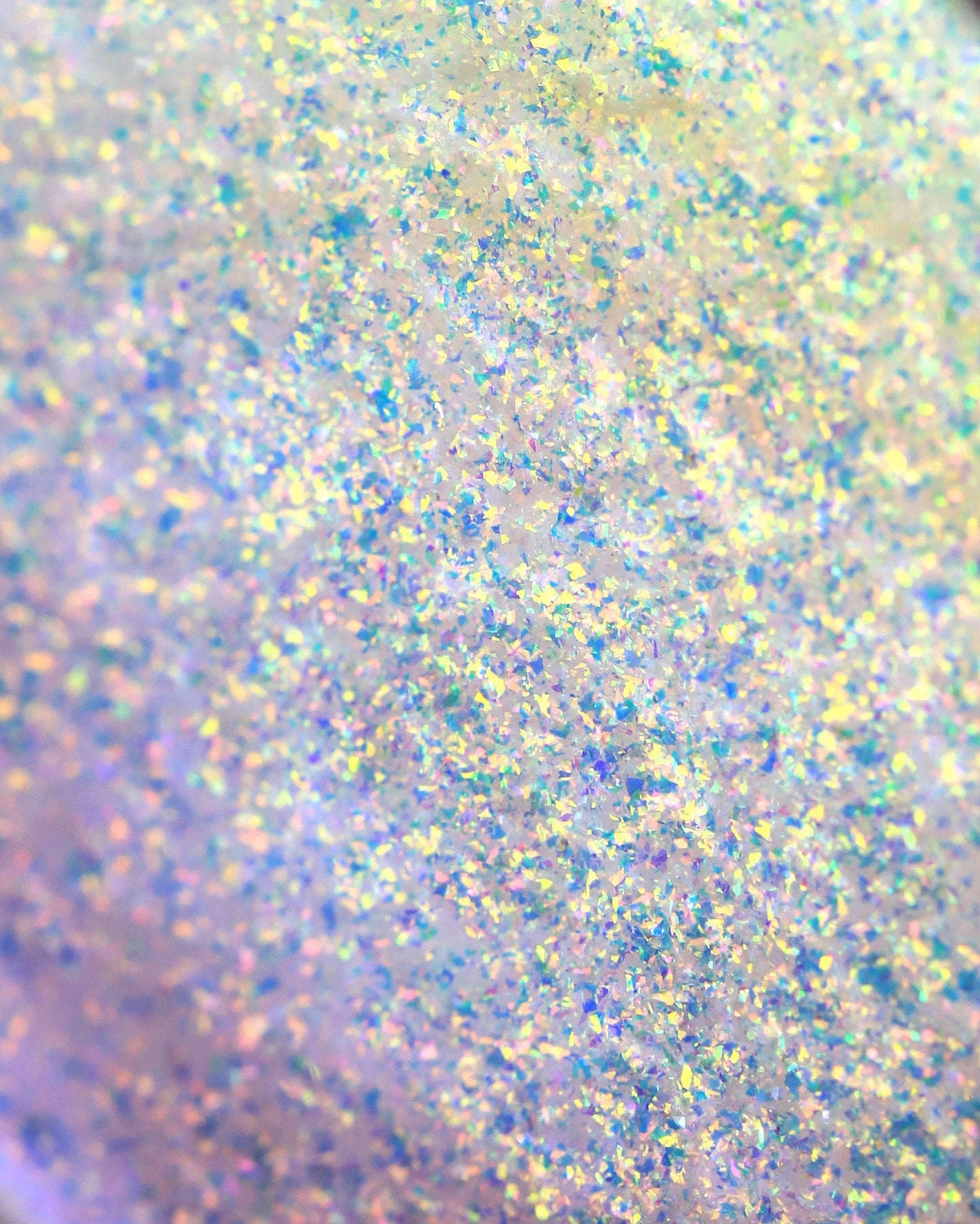 Close-up of glittery powder with multicolor specks on a light background