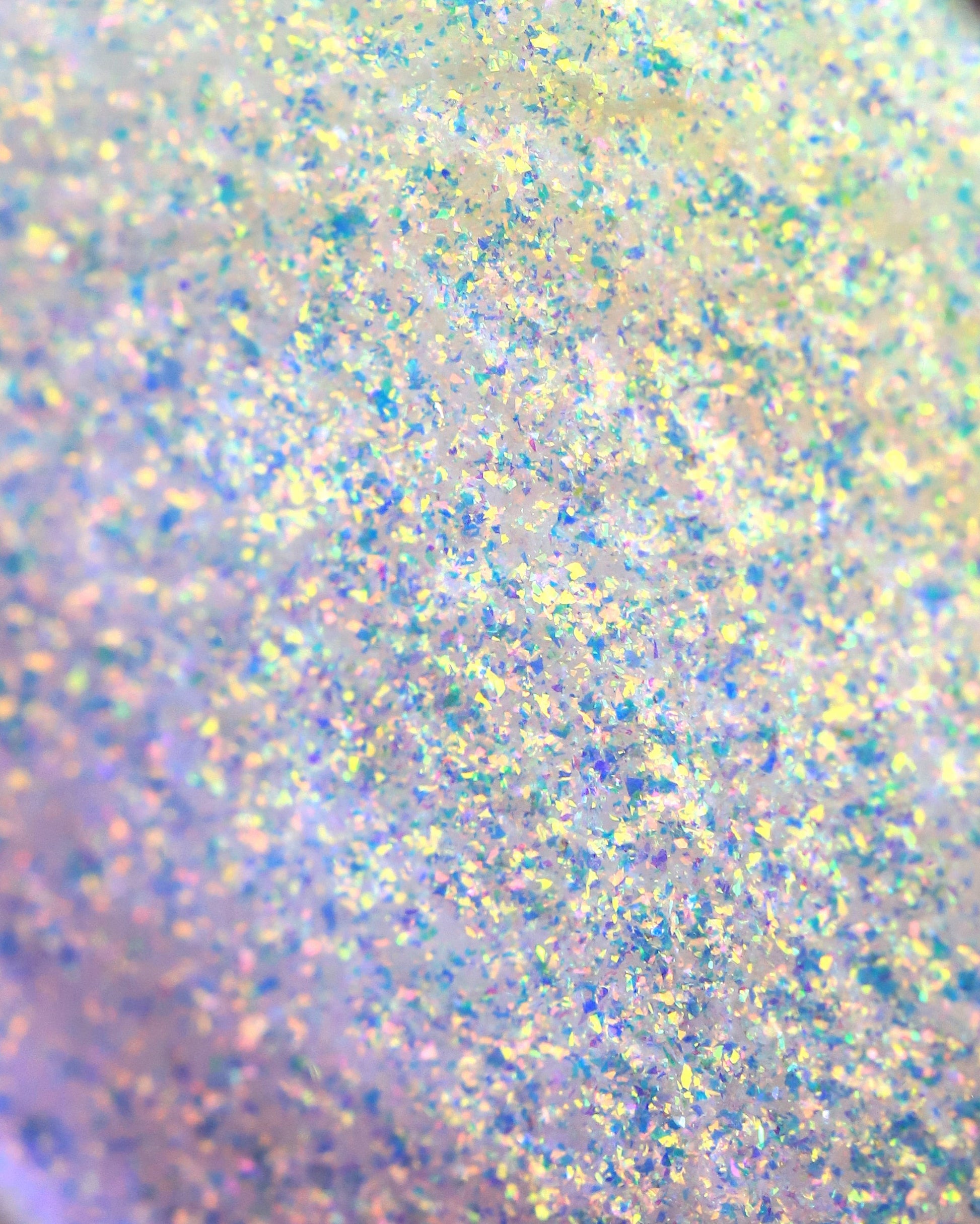 Close-up of glittery powder with multicolor specks on a light background