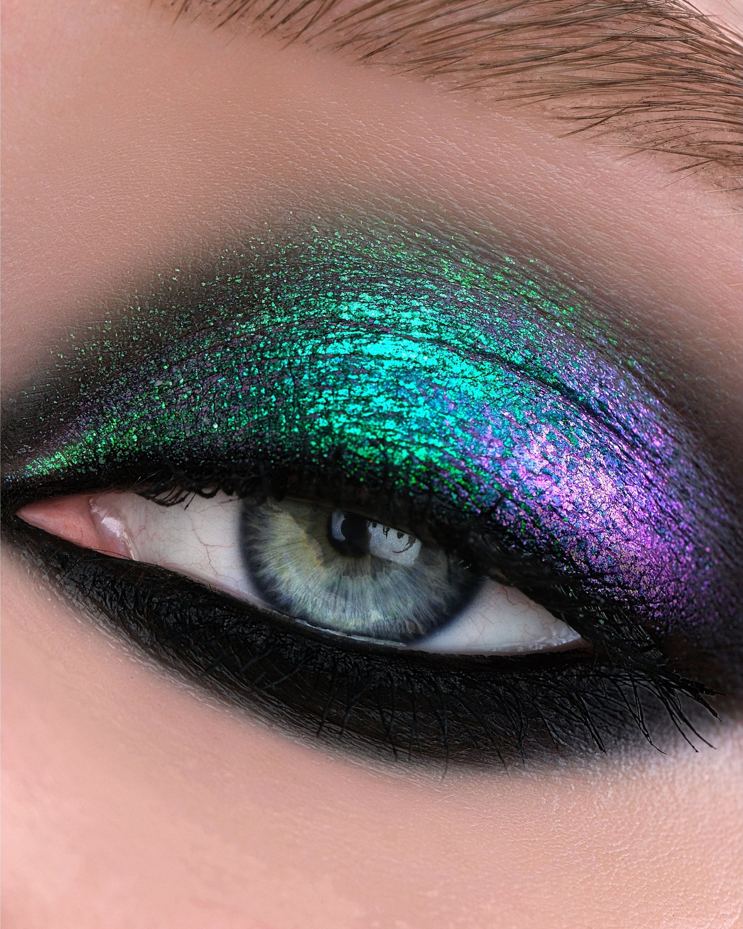 Close-up of a eye with green and purple makeup