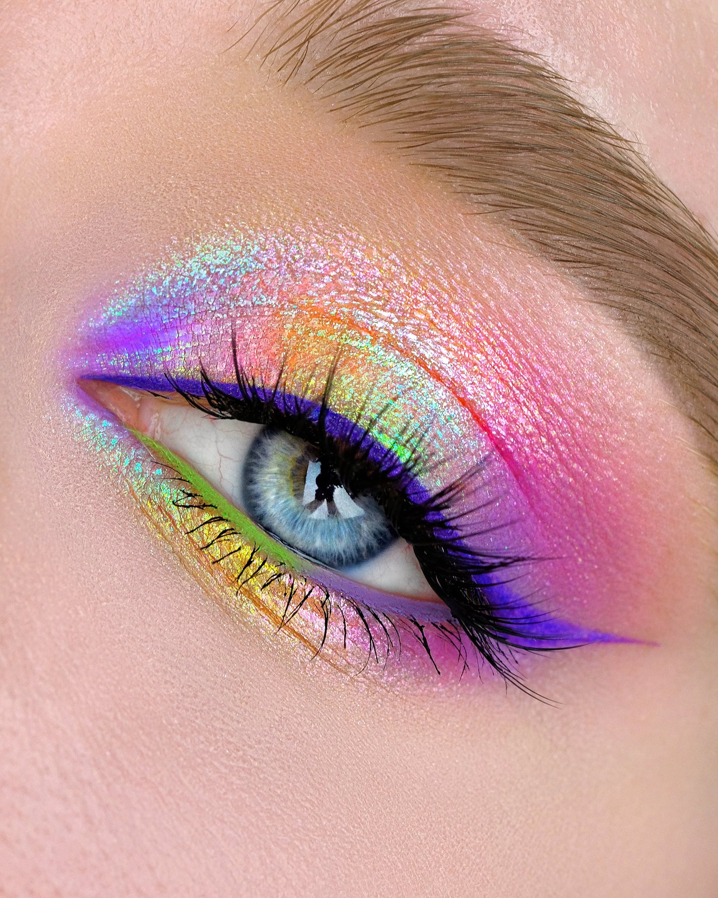 Close-up of a colorful eye makeup with a rainbow effect 