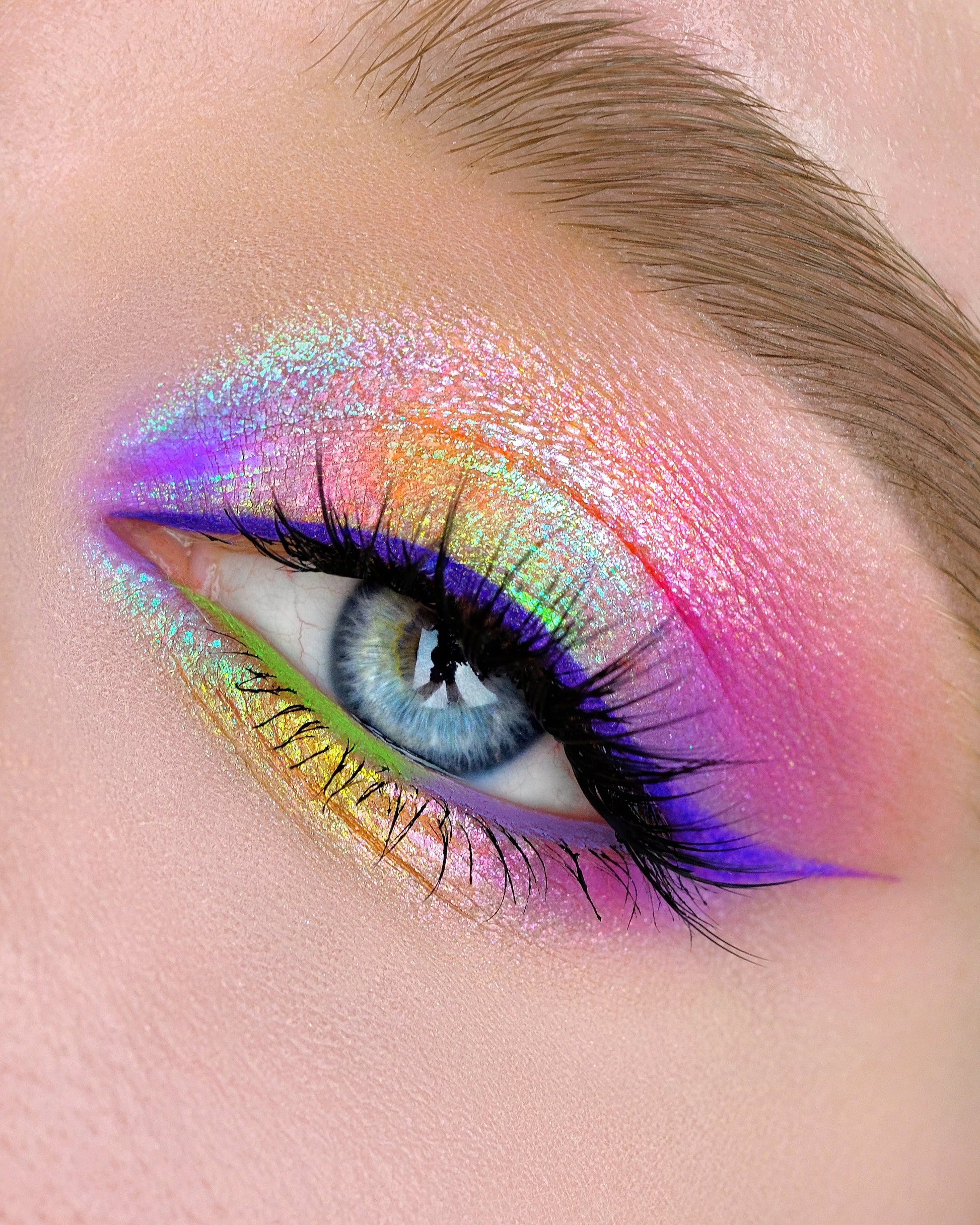 Close-up of a colorful eye makeup with a rainbow effect 